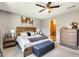 Relaxing bedroom with a king bed, ensuite bathroom access, and stylish bedside tables at 14393 W Wethersfield Rd, Surprise, AZ 85379