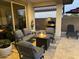 Covered patio with comfortable seating, a fire pit, and a built-in grill, perfect for outdoor gatherings at 14393 W Wethersfield Rd, Surprise, AZ 85379