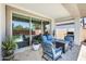Cozy outdoor patio with comfortable seating, a fire pit, and views of the pool at 14393 W Wethersfield Rd, Surprise, AZ 85379