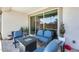 Inviting covered patio with a stylish seating area around a fire pit and sliding glass doors overlooking the pool at 14393 W Wethersfield Rd, Surprise, AZ 85379