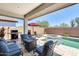 Inviting patio with a seating area, grill, and a refreshing pool and spa at 14393 W Wethersfield Rd, Surprise, AZ 85379