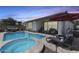 Beautiful pool and spa featuring a lounging area and a covered outdoor living space in the backyard at 14393 W Wethersfield Rd, Surprise, AZ 85379