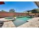 A sparkling pool, spa, and patio are the perfect backdrop for relaxing and entertaining in this backyard retreat at 14393 W Wethersfield Rd, Surprise, AZ 85379
