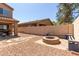 Private backyard features a gravel landscape, brick pavers and a built-in fire pit at 14436 N 162Nd Ln, Surprise, AZ 85379