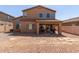 The backyard has a gravel-covered landscape, a covered patio, and a built-in BBQ grill at 14436 N 162Nd Ln, Surprise, AZ 85379