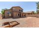 Spacious backyard with gravel landscaping, a covered patio, and plenty of room for activities at 14436 N 162Nd Ln, Surprise, AZ 85379