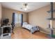 Bedroom with a ceiling fan, desk, and cat tree at 14436 N 162Nd Ln, Surprise, AZ 85379