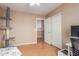 Bedroom with wood floors, closet, cat tree, desk and tv at 14436 N 162Nd Ln, Surprise, AZ 85379