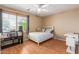 Bright bedroom with a ceiling fan, a large window, and a comfortable bed and desk at 14436 N 162Nd Ln, Surprise, AZ 85379