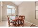Formal dining area featuring a large table, seating for six, and natural light at 14436 N 162Nd Ln, Surprise, AZ 85379