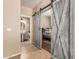 Hallway showing a bathroom and bedroom through barn doors at 14436 N 162Nd Ln, Surprise, AZ 85379