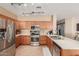 Updated kitchen with stainless appliances, modern lighting, and tile floors at 14436 N 162Nd Ln, Surprise, AZ 85379