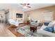 Bright living room features a ceiling fan and comfortable seating for entertaining guests at 14436 N 162Nd Ln, Surprise, AZ 85379