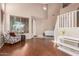 Bright living room featuring wood floors, a cozy chair, and neutral decor at 14436 N 162Nd Ln, Surprise, AZ 85379