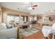 Comfortable living room with bright light, ceiling fan, and open floor plan at 14436 N 162Nd Ln, Surprise, AZ 85379