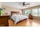Comfortable bedroom featuring a large window, ceiling fan, and a spacious layout at 14436 N 162Nd Ln, Surprise, AZ 85379