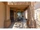 Covered patio with a chair and view of the front yard. Chandelier hanging at 14436 N 162Nd Ln, Surprise, AZ 85379