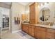 Bathroom with double sinks, granite counters, and custom built-in storage at 1535 W Winter Dr, Phoenix, AZ 85021