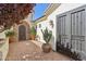 Private courtyard with beautiful potted plants and secure iron gates at 1535 W Winter Dr, Phoenix, AZ 85021