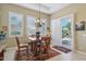 Bright dining room with shuttered windows and sliding door access to a landscaped yard at 1535 W Winter Dr, Phoenix, AZ 85021