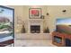 Living room with a stone fireplace, tile floors, and backyard views at 1535 W Winter Dr, Phoenix, AZ 85021