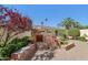 Outdoor stone fireplace with decorative features and surrounding greenery for serene backyard ambiance at 1535 W Winter Dr, Phoenix, AZ 85021