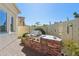 Outdoor stainless steel grill built into brick structure surrounded by lush desert landscaping at 1535 W Winter Dr, Phoenix, AZ 85021