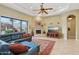 Comfortable living room with a fireplace, tile floors, and large windows at 1535 W Winter Dr, Phoenix, AZ 85021