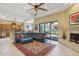 Spacious living area with a fireplace, tile floors, and access to the backyard at 1535 W Winter Dr, Phoenix, AZ 85021
