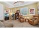 Cozy living room with a ceiling fan, comfortable seating, and built-in shelving with decor at 1535 W Winter Dr, Phoenix, AZ 85021