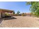 Large backyard featuring desert landscaping and covered patio at 2056 E San Tan Ct, Gilbert, AZ 85296