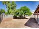 The backyard features low maintenance desert landscaping, mature trees, and a block wall at 2822 N 90Th Ave, Phoenix, AZ 85037