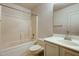 Bright bathroom showcasing a tub and shower combination, vanity, and neutral finishes at 2822 N 90Th Ave, Phoenix, AZ 85037
