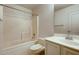 Bright bathroom showcasing a tub and shower combination, vanity, and neutral finishes at 2822 N 90Th Ave, Phoenix, AZ 85037