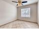 Bedroom featuring bright tile floors, ceiling fan, and neutral paint at 2822 N 90Th Ave, Phoenix, AZ 85037