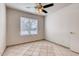 Bedroom featuring bright tile floors, ceiling fan, and neutral paint at 2822 N 90Th Ave, Phoenix, AZ 85037