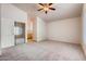 Bedroom with neutral carpet, ceiling fan, and mirrored closet doors at 2822 N 90Th Ave, Phoenix, AZ 85037