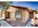 Exterior view of a home featuring a stylish front door, tiled roof, and low-maintenance desert landscaping at 2822 N 90Th Ave, Phoenix, AZ 85037