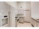 Well-maintained kitchen with white appliances, white cabinets, and tile flooring at 2822 N 90Th Ave, Phoenix, AZ 85037