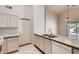 Bright kitchen with white cabinets, stainless steel appliances, and marble countertops at 2822 N 90Th Ave, Phoenix, AZ 85037
