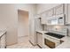 Bright kitchen featuring white appliances, ample counter space, and white cabinetry at 2822 N 90Th Ave, Phoenix, AZ 85037