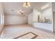 Open-concept living area with tile floors, ceiling fans, and a breakfast bar connecting to the kitchen at 2822 N 90Th Ave, Phoenix, AZ 85037