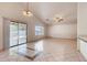 Spacious living room boasts tile flooring, vaulted ceilings, sliding door access, and bright natural light at 2822 N 90Th Ave, Phoenix, AZ 85037