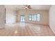 Bright and airy living space featuring tile flooring, large windows, and sliding glass doors to the backyard at 2822 N 90Th Ave, Phoenix, AZ 85037