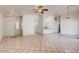 The home boasts an open floor plan connecting the living area to the kitchen with white cabinets and neutral finishes at 2822 N 90Th Ave, Phoenix, AZ 85037