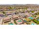 Wide aerial shot of homes with pools and desert landscape, set against a backdrop of rolling mountains at 31453 N Blackfoot Dr, San Tan Valley, AZ 85143