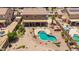 An aerial view showcases the backyard with pool, patio, lounge area and beautiful greenery at 31453 N Blackfoot Dr, San Tan Valley, AZ 85143