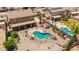 Aerial view of a backyard oasis with pool, spa, patio furniture, and lush landscaping at 31453 N Blackfoot Dr, San Tan Valley, AZ 85143