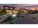 Sprawling backyard showcasing lush landscaping, a sparkling pool, covered patio, and desert flora at 31453 N Blackfoot Dr, San Tan Valley, AZ 85143