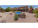 Fully landscaped backyard features a sparkling pool, rock details, and desert plants at 31453 N Blackfoot Dr, San Tan Valley, AZ 85143
